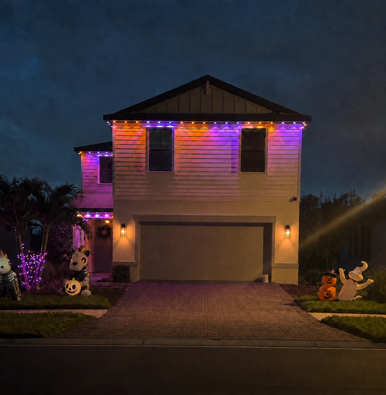 Two-story Florida home with permanent Govee outdoor lighting installed along the roofline at night